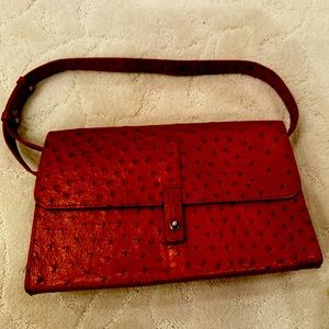 An orange brown boxy, shoulder bag made by DKNY